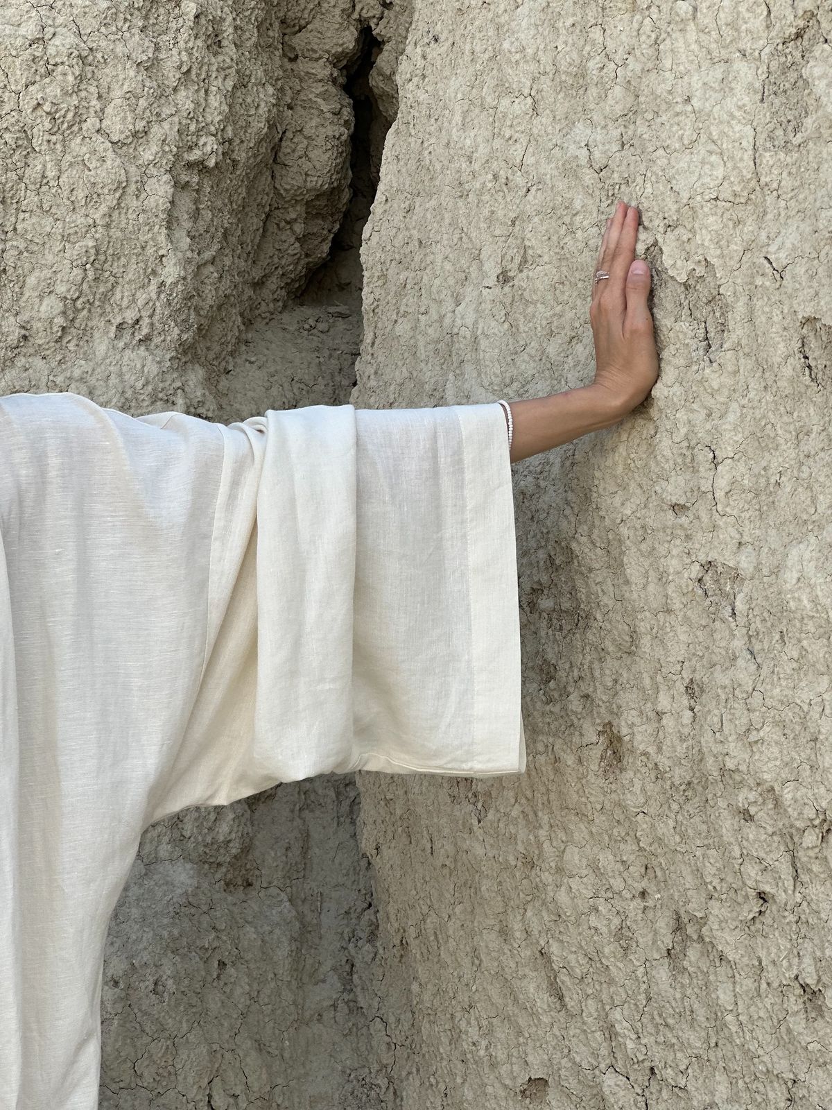 Hand on an earth wall
